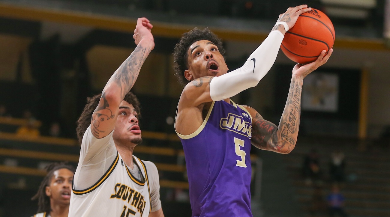 James Madison Dukes guard Terrence Edwards Jr. (5) is defended by Southern Miss Golden Eagles guard Donovan Ivory (15) during the first half at Reed Green Coliseum in Hattiesburg, Mississippi, on Jan. 6, 2024.